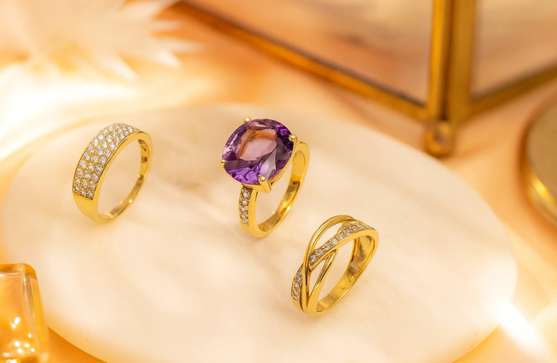 Kelowna jewelers showcasing gold rings with gemstones and diamonds