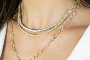 Layered gold rope and link chains with a silver tennis necklace